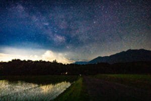 A starry sky rising above rice paddies in rural Yamanashi Prefecture