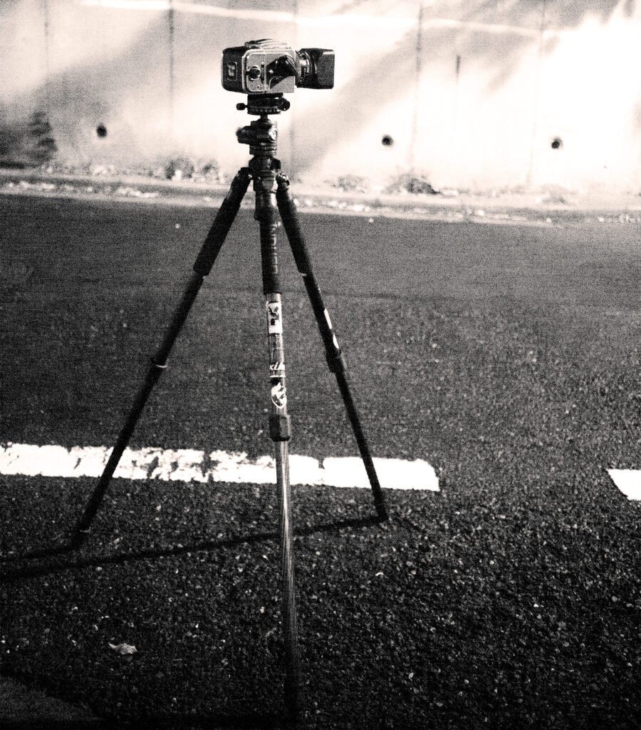 Photo of a medium format film camera on a tripod during a night photography session